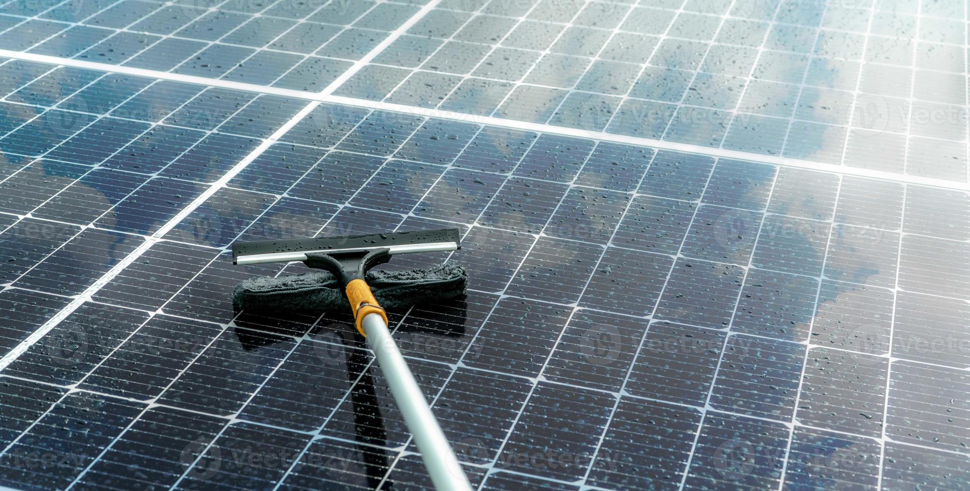 cleaning-solar-panel-with-microfiber-mop-on-wet-roof-solar-panel-orvoltaic-module-maintenance-service-sustainable-resource-solar-power-green-energy-sustainable-development-technology-photo