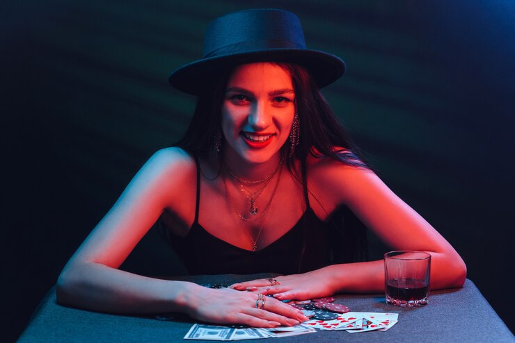 gambling-girl-hat-plays-poker-table-with-cards-with-red-lights-dark-background_118086-4055