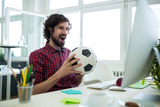 male-graphic-designer-cheering-while-watching-football-match (1)