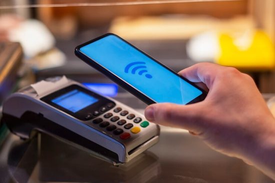 smartphone-shop-using-nfc-technology-against-background-payment-terminal_115838-682