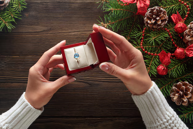 hands-holding-box-with-ring-with-blue-stone_1208-330