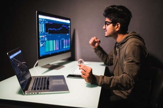 indian-trader-with-bitcoin-checking-stock-trading-data-analysis-concept-working-office-with-financial-graph-computer-monitors_231208-3652