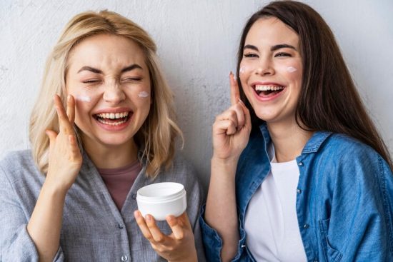 portrait-women-laughing-playing-with-moisturizer_23-2148850636