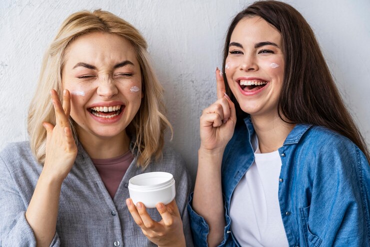 portrait-women-laughing-playing-with-moisturizer_23-2148850636