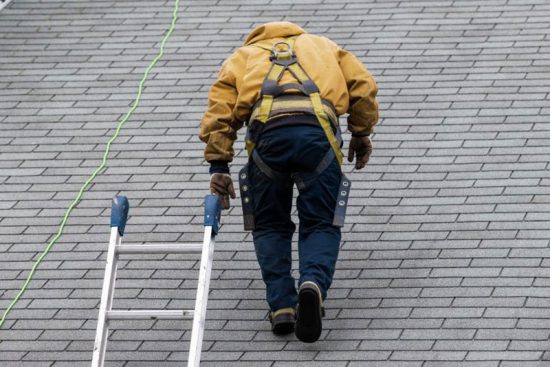 roofer-walking-up-shingle-roof-chino-hills-ca