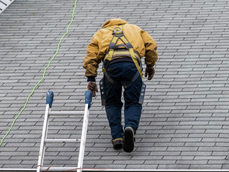 roofer-walking-up-shingle-roof-chino-hills-ca