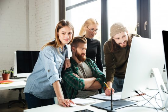 colleagues-office-talking-with-each-other-using-computer_171337-6849