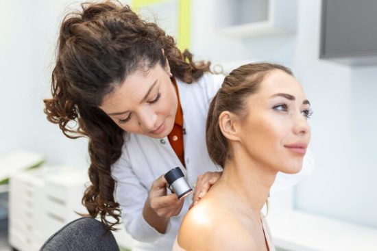 dermatologist-latex-gloves-holding-dermatoscope-while-examining-attractive-patient-with-skin-disease-female-dermatologist-examining-patient-with-dermascope-looking-signs-skin-cancer_657921-299