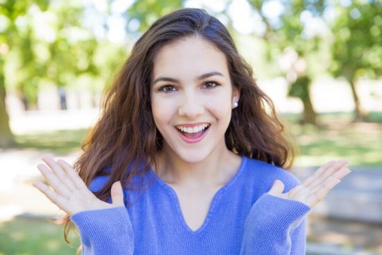 happy-pretty-young-woman-throwing-up-hands-park_1262-20565