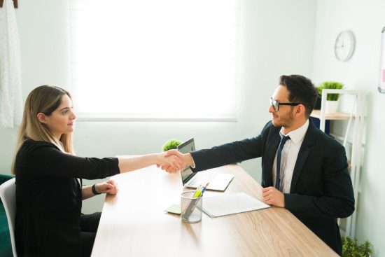 male-human-resources-manager-suit-shaking-hands-with-attractive-professional-woman-after-hiring-her-new-job (1)