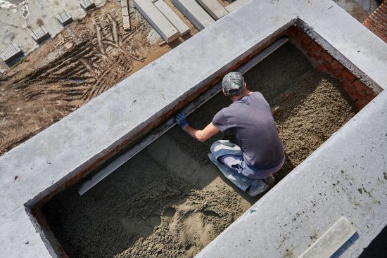 male-worker-screeding-floor-construction-site (1)