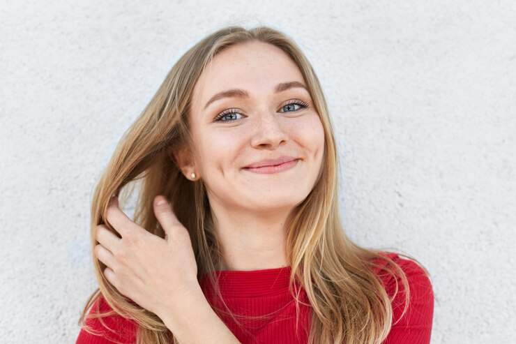 pleased-woman-with-blonde-hair-luminous-eyes-gentle-smile-having-dimples-cheeksl_176532-7246