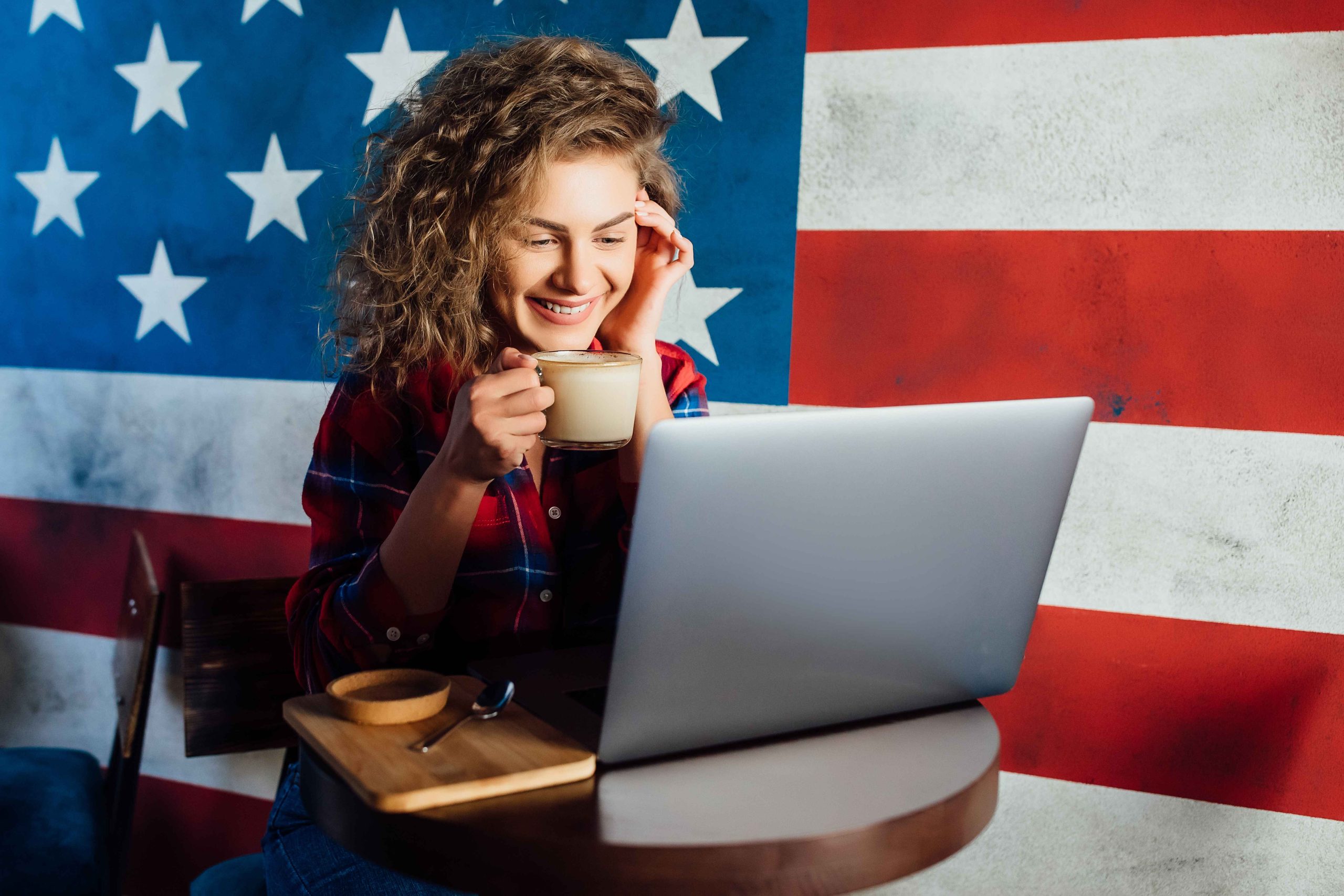 pretty-happy-woman-using-laptop-while-sitting-cafe-young-woman-sitting-coffee-shop-working-laptop (1)